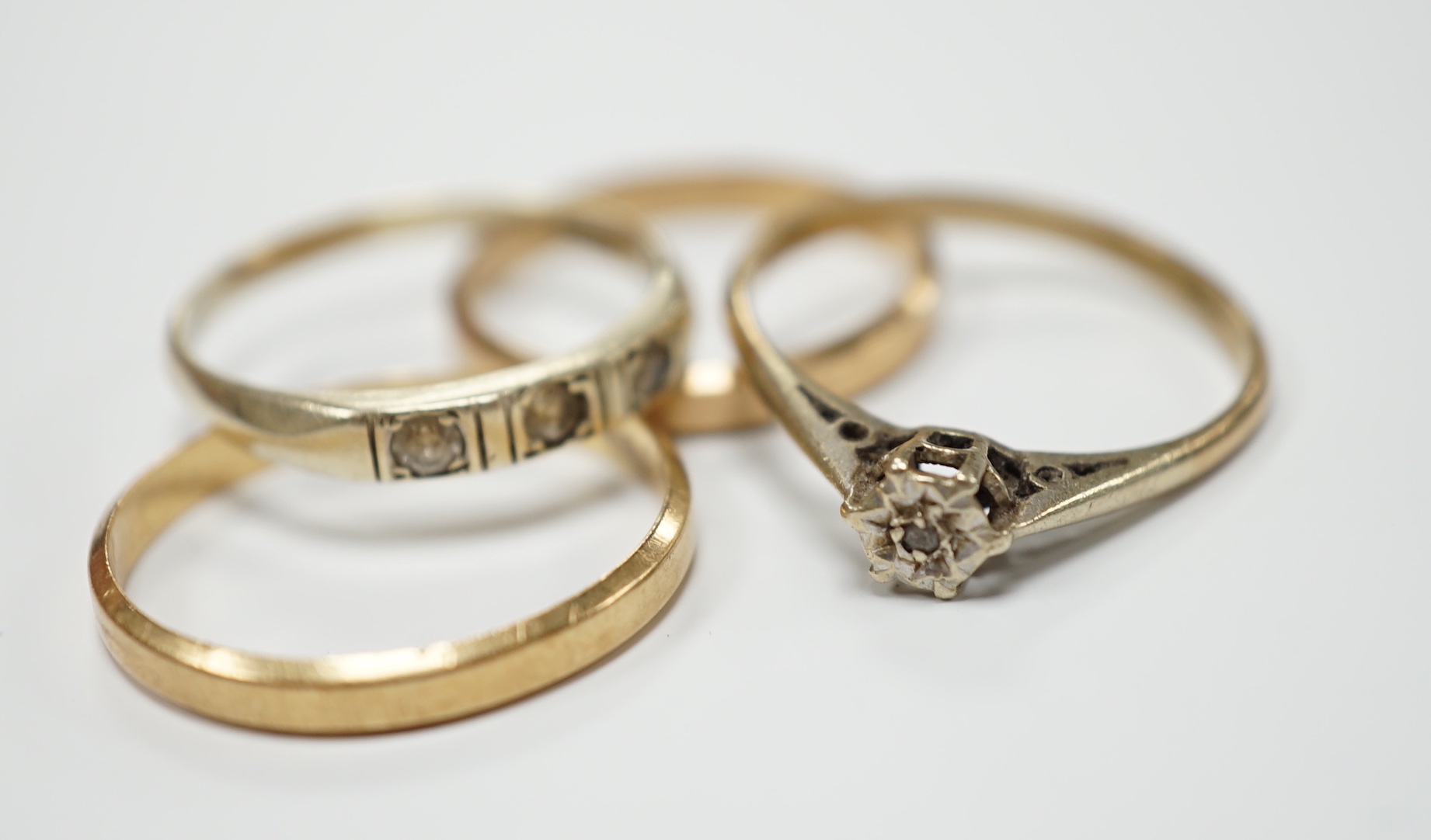 Two 585 yellow metal wedding bands, 4.1 grams and two 9ct gold and gem set rings, gross weight 4.2 grams.